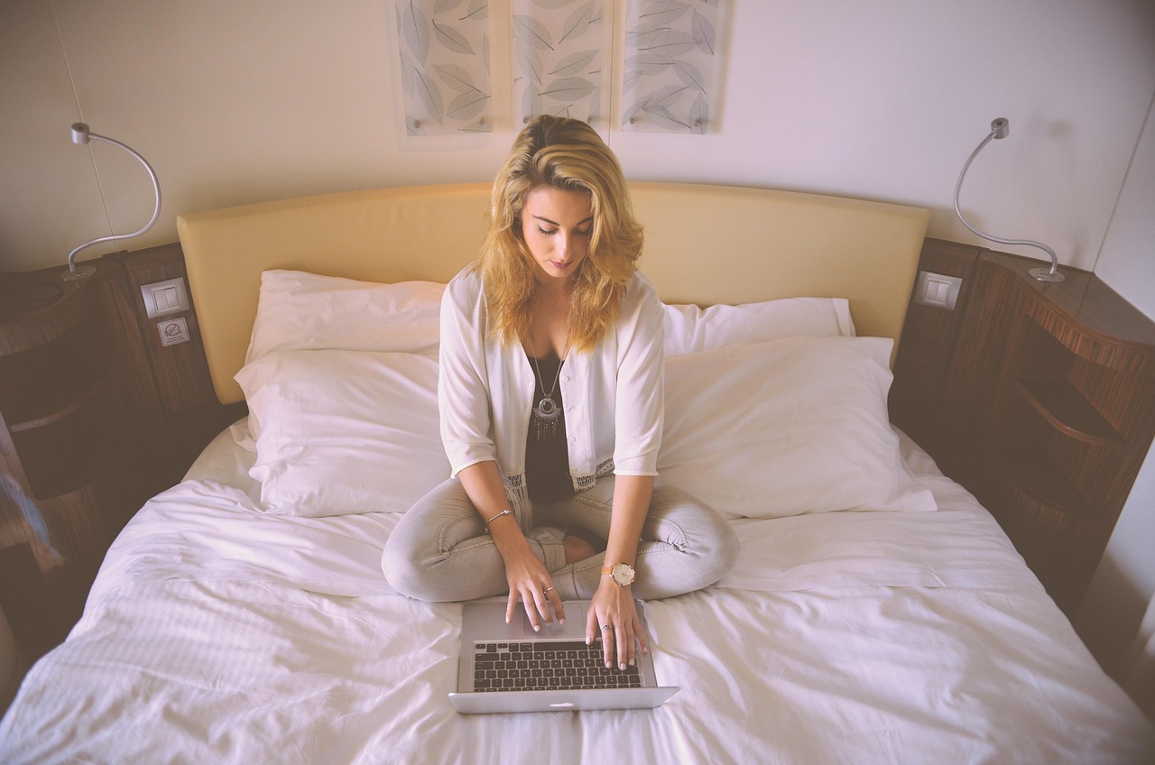 Woman, working, bed — MT4 WebTrader Offers Browser-Based Access With No Downloads